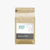 Freshly roasted Caffeeegy.Co packaging of freshly roasted American coffee in a beige resealable bag