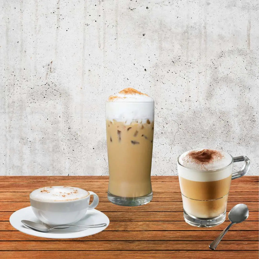 Caffeeegy Co espresso trio of cappuccino iced latte and macchiato on wood table featuring locally roasted coffee