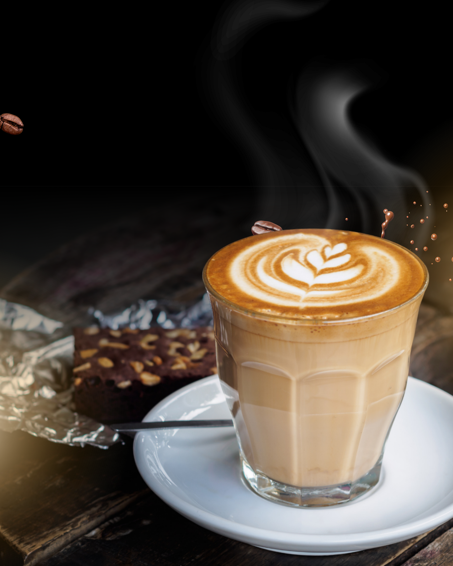 Glass of latte coffee with latte art on white saucer next to brownie using premium coffee powder