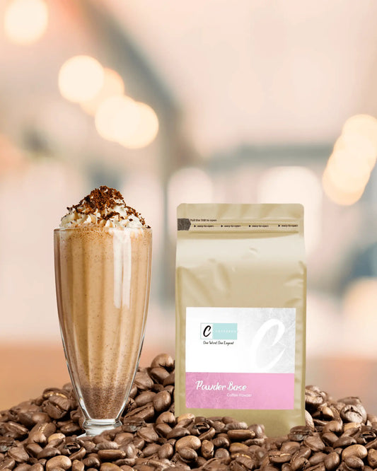 Caffeeegy.Co premium coffee powder bag next to a frosty coffee beverage with whipped cream