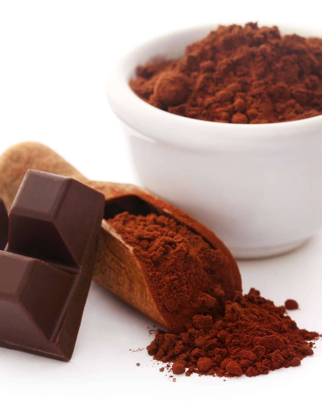 Caffeeegy.Co premium chocolate powder in a bowl with cocoa and chocolate pieces nearby