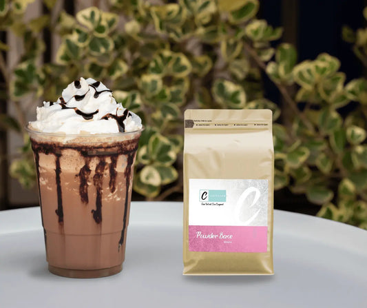 Caffeeegy.Co handcrafted mocha coffee mix beside a whipped cream topped mocha drink