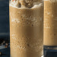 Iced coffee blended drink made with premium coffee powder, topped with whipped cream and a straw