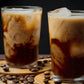 Iced coffee drinks made with premium coffee powder served on a wooden tray with coffee beans