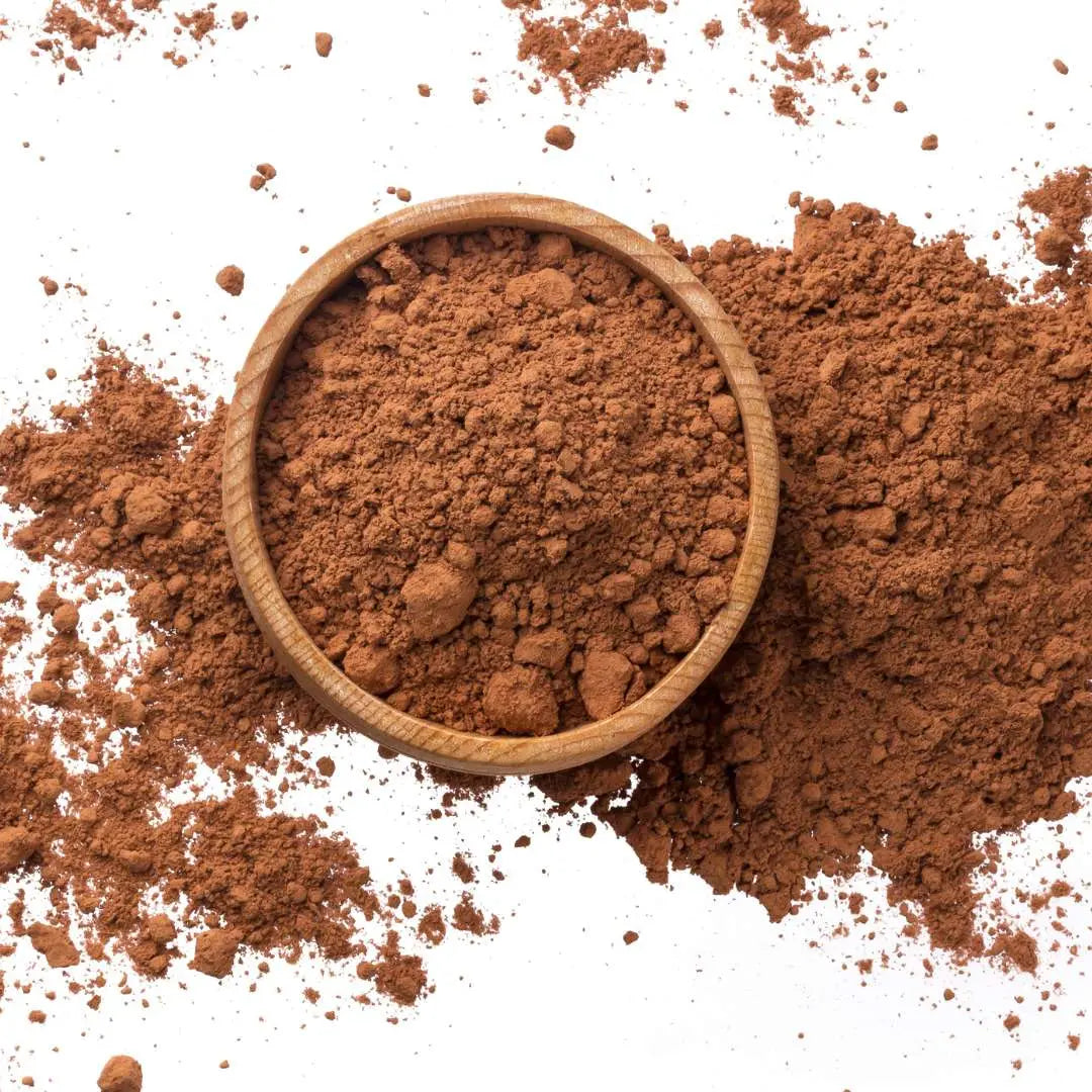 Caffeeegy.Co authentic cocoa flavors powder in a wooden bowl on a white background